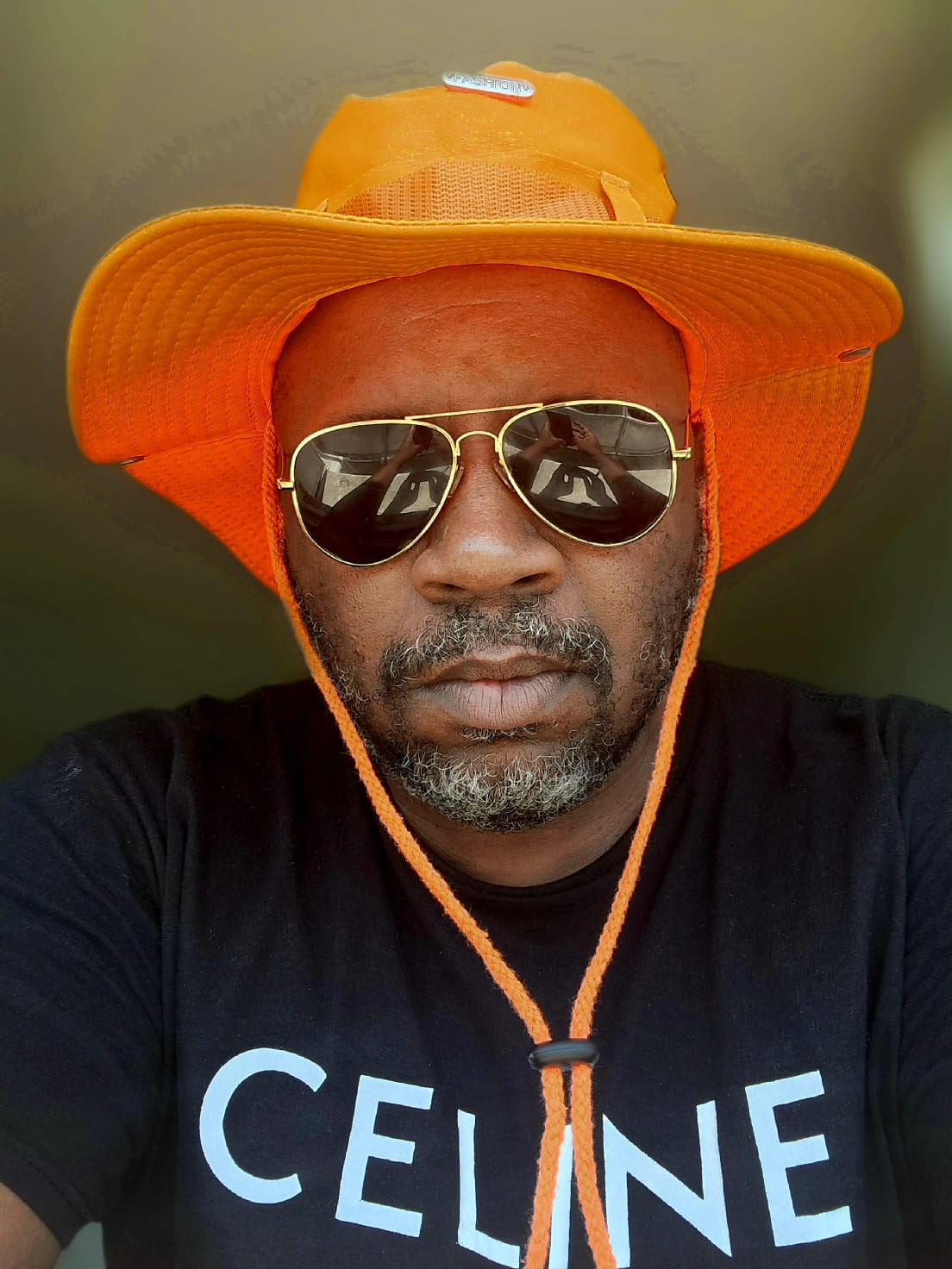 a man wearing a hat and sunglasses